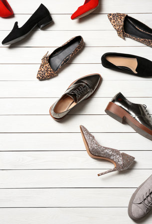 Flat lay composition with stylish shoes and space for text on wooden backgroundの写真素材