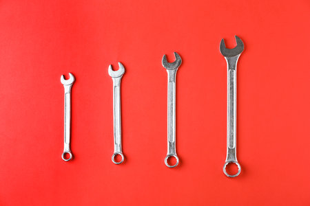 New wrenches on color background, top view. Plumber Toolsの写真素材