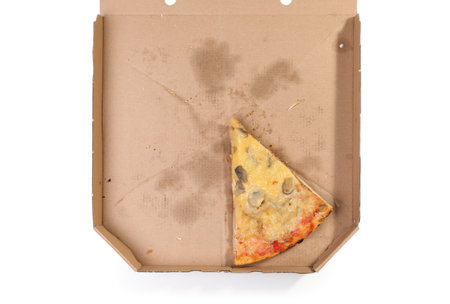 Cardboard box with pizza piece on white background, top viewの写真素材