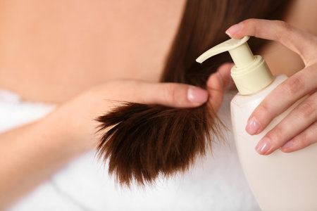 Woman applying hair conditioner, closeup. split endsの写真素材