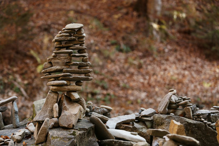 Tower of balancing stones in forest. Space for textの写真素材
