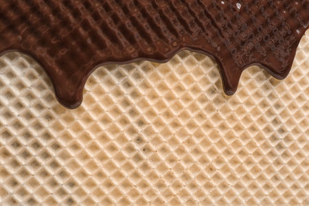 Hot dark chocolate on wafer, closeup. Crispy foodの写真素材