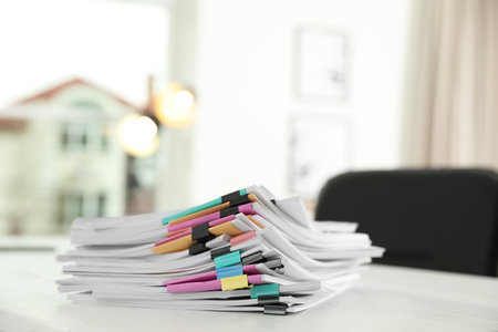 Stack of documents with paper clips on office table. Space for textの写真素材