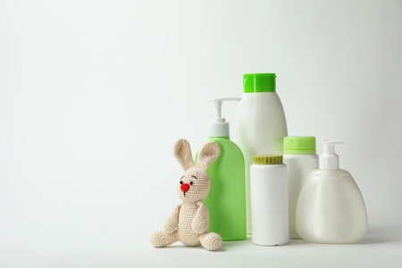 Baby cosmetic products and toy on white backgroundの写真素材