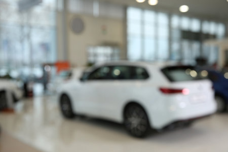 Blurred view of large car dealership interiorの写真素材