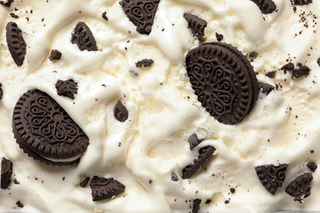 Tasty ice cream with chocolate sandwich cookies as background, top viewの写真素材
