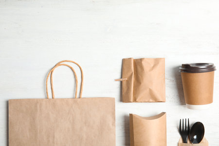 Different containers for mock up design on wooden background, flat lay. food delivery serviceの写真素材