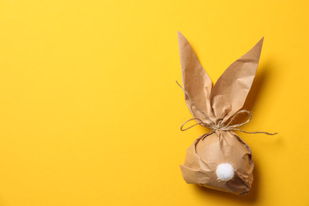 Creative Easter bunny gift bag on color background, top view with space for textの写真素材