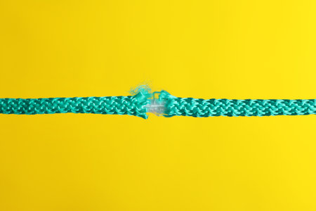 Rupture of blue rope on color backgroundの写真素材