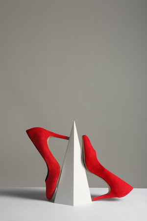 Composition with elegant female shoes on table against gray background. Space for textの写真素材