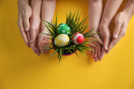 Family with composition of plant and Easter eggs on color background, top viewの写真素材