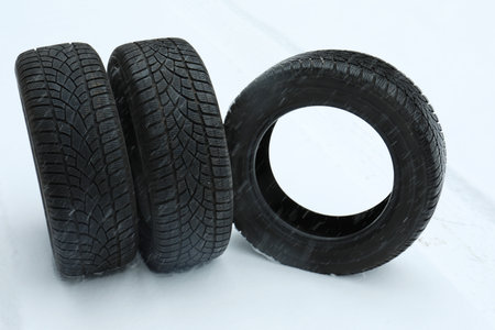 New winter tires on fresh snow outdoors