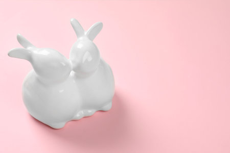 Ceramic Easter bunnies on color background, space for textの写真素材