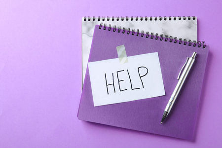 Flat lay composition with stationery, note HELP and space for text on color backgroundの写真素材