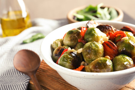 Bowl of warm salad with Brussels sprouts and carrots on tableの写真素材