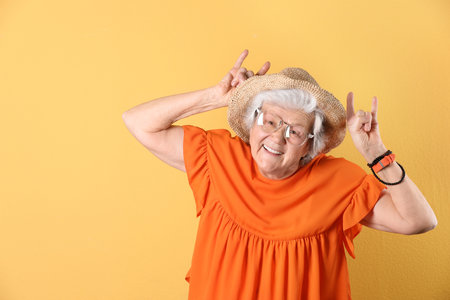 Portrait of cool grandmother on color background, space for textの写真素材