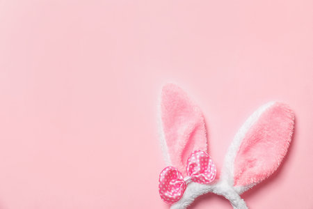 Funny headband with Easter bunny ears on color background, top view. Space for textの写真素材