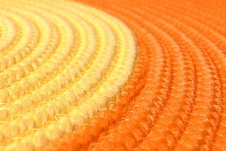 Orange and yellow wicker mat texture as background, closeupの写真素材