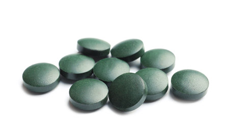Spirulina tablets on white background. healthy lifestyleの写真素材