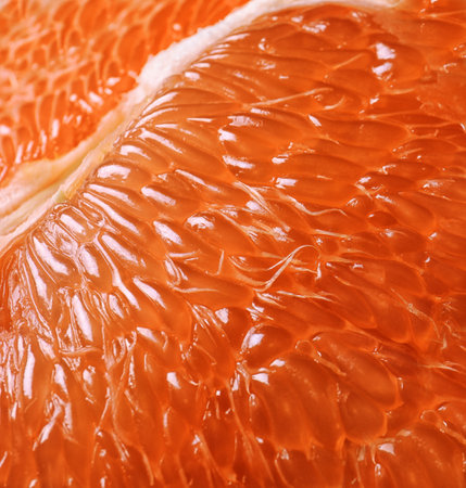 Peeled ripe grapefruit as background, closeup. orange citrus fruitsの写真素材
