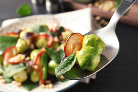 Spoon with tasty Brussels sprouts salad over table, closeupの写真素材