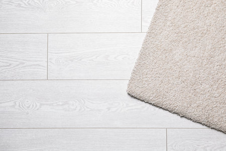 Fuzzy carpet on wooden background, top view with space for textの写真素材