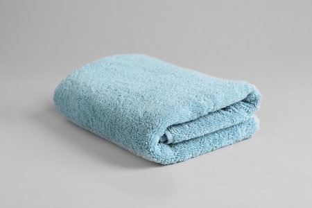 Fresh fluffy folded towel on gray backgroundの写真素材