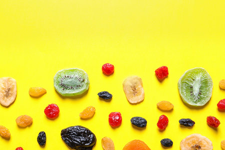 Different dried fruits on color background, top view with space for text. healthy lifestyleの写真素材
