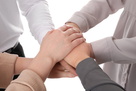Group of people holding their hands together on white background, closeupの写真素材