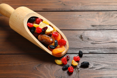 Scoop with different dried fruits on wooden background, space for text. healthy lifestyleの写真素材