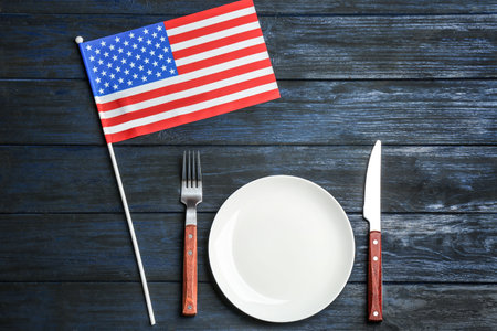 Patriotic table setting with USA flag on wooden background, flat layの写真素材