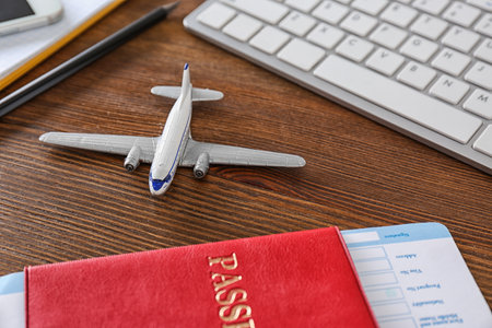 Composition with airplane model on wooden table. travel agency concept