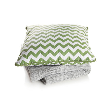 Stylish soft pillow and folded plaid on white backgroundの写真素材