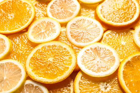 Slices of fresh citrus fruits as backgroundの写真素材