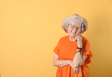 Portrait of cool grandmother on color background, space for text