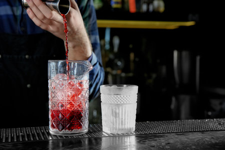 Barman making Red Russian cocktail at counter in pub, closeup. Space for textの写真素材