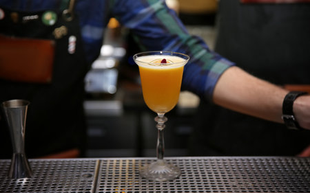 Glass of tasty cocktail on bar counterの写真素材