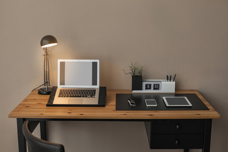 Modern workplace interior with laptop and devices on table. Space for textの写真素材