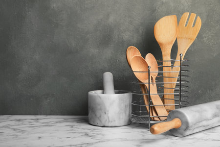 Different kitchen utensils and mortar on table. Space for textの写真素材