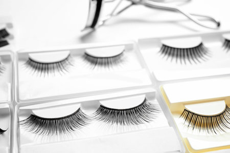 Set with different false eyelashes in packs as background, closeupの写真素材