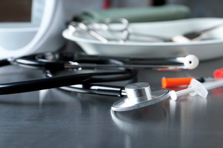 Stethoscope and syringes on gray table. medical objectsの写真素材