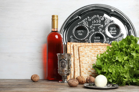 Symbolic Passover (Pesach) items on table against wooden background, space for textの写真素材