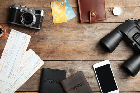 Flat lay composition with tourist items and space for text on wooden background. travel agencyの写真素材