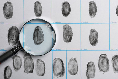 Magnifying glass and criminal fingerprint card, top viewの写真素材