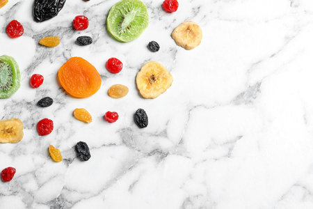 Different dried fruits on marble background, top view with space for text. healthy lifestyleの写真素材