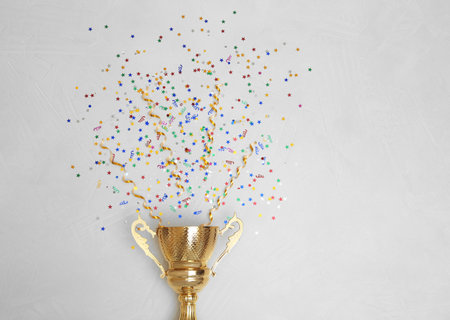 Trophy and confetti on light background, top view with space for text. Victory conceptの写真素材
