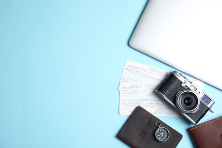 Flat lay composition with passport, camera and tickets on color background, space for text. travel agencyの写真素材