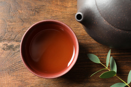 Cup of freshly brewed oolong tea on wooden table, top viewの写真素材