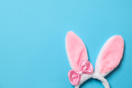 Funny headband with Easter bunny ears on color background, top view. Space for textの写真素材
