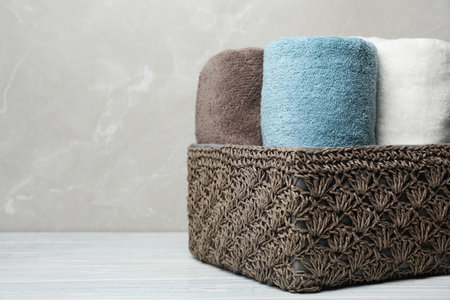 Basket of fresh towels on table. Space for textの写真素材